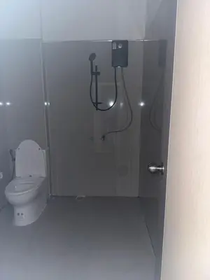 a bathroom with a shower stall with a toilet at Kami Guest House Patong in Patong Beach