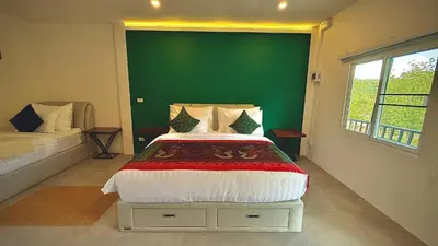 a bedroom with a bed and a green wall at The Simple Place - King and Twin in Klong Muang Beach