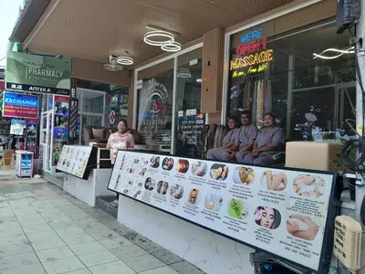 a group of people sitting behind the counter of a restaurant at Island Patongbeach Apartments in Patong Beach