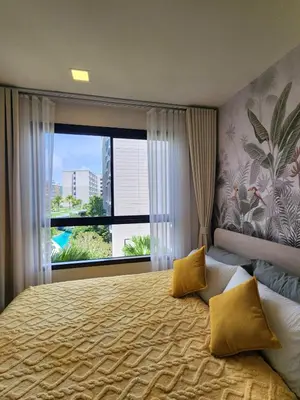 a bedroom with a large bed with a large window at Cozy Palm Haven apartment in Kathu