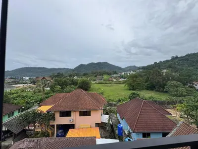 a view of a village with houses and mountains at Rare Find Penthouse with Private Office and Jungle Mountrain Views in Kamala Beach