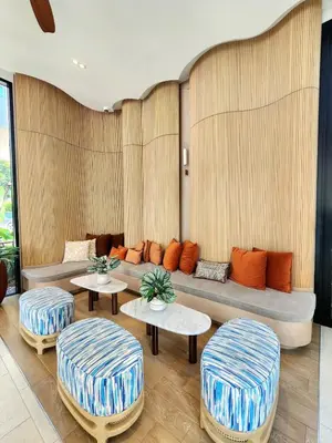 a living room with a couch and two stools at Cozy Minimalist room in Kathu