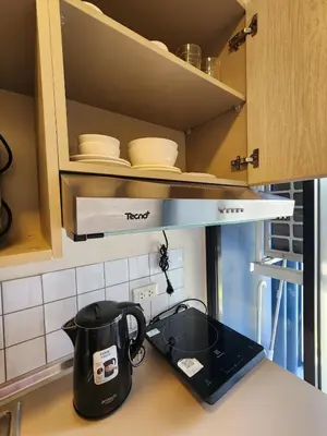 a tea kettle on a counter in a kitchen at Cozy Minimalist room in Kathu