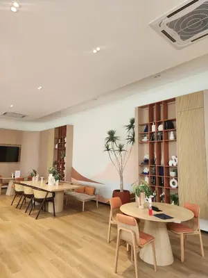 a lobby with tables and chairs and a couch at Cozy Minimalist room in Kathu
