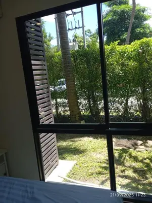 an open window with a view of a yard at The Title Rawai Beach Front 1bdr in Rawai Beach