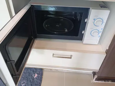 a microwave oven sitting on top of a cabinet at The Title Rawai Beach Front 1bdr in Rawai Beach
