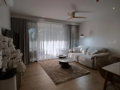 a living room with a couch and a table at Bang Tao - Laguna Beachside 3BR Apartment 130 sq m in Bang Tao Beach