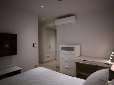 a bedroom with a bed and a desk and a desk at Bang Tao - Laguna Beachside 3BR Apartment 130 sq m in Bang Tao Beach