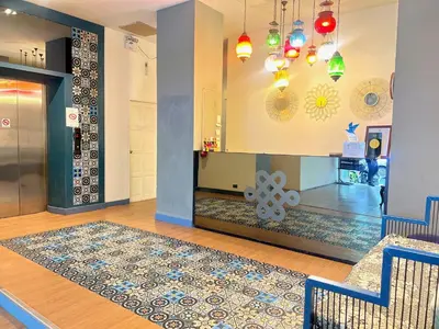 a room with a rug on a wooden floor and a hallway at Acca Patong Residence in Patong Beach