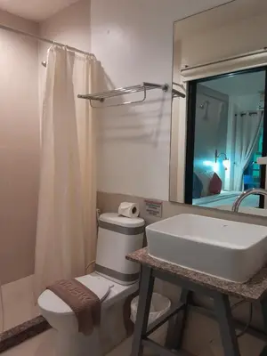 a bathroom with a sink and a toilet and a mirror at Acca Patong Residence in Patong Beach