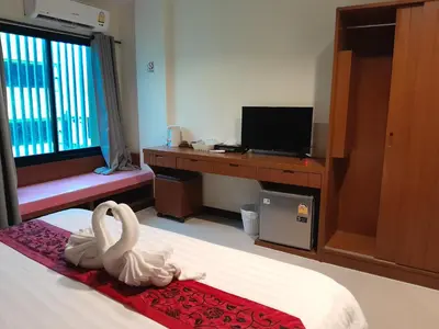 a hotel room with two swans sitting on a bed at Acca Patong Residence in Patong Beach