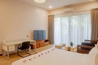a hotel room with a desk and a bed and a desk at 4BR Laguna Golf View Pool Villa Retreats Phuket in Laguna Phuket