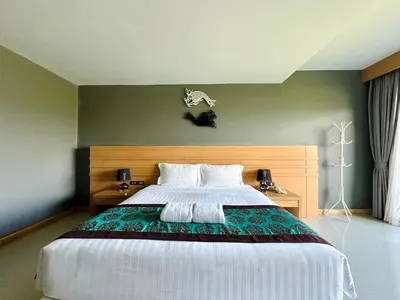 a bedroom with a large bed in a room at The Par Phuket Hotel in Kathu