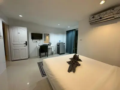 a bedroom with a bed with a bow on it at Patong gray house in Patong Beach