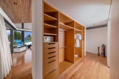 a room with a large closet with wooden shelves at Villa Cielo in Ban Han Pa To