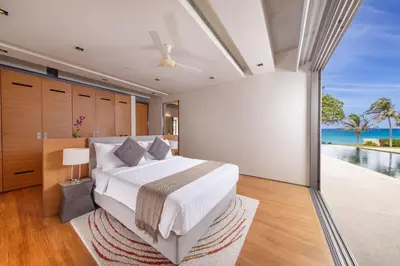 a bedroom with a bed with a view of the ocean at Villa Cielo in Ban Han Pa To