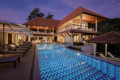 a swimming pool in front of a house at Katamanda Villa Allegra 5 bedroom Seaview villa in Ban Karon