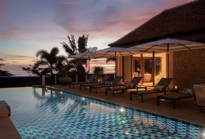 a resort swimming pool with lounge chairs and umbrellas at Katamanda Villa Allegra 5 bedroom Seaview villa in Ban Karon