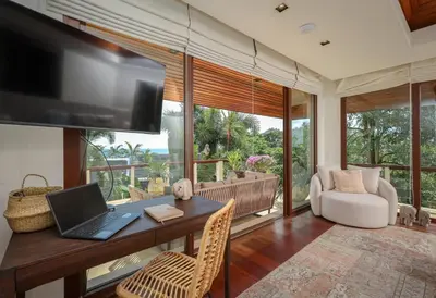 a living room with a desk with a laptop on it at Katamanda Villa Allegra 5 bedroom Seaview villa in Ban Karon