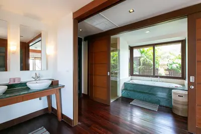 a bathroom with two sinks and a bath tub at Katamanda Villa Allegra 5 bedroom Seaview villa in Ban Karon