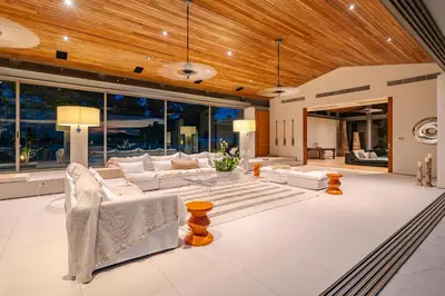 a living room with white furniture and a wooden ceiling at Villa Essenza in Ban Han Pa To