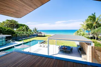 an outdoor deck with a view of the ocean at Villa Essenza in Ban Han Pa To