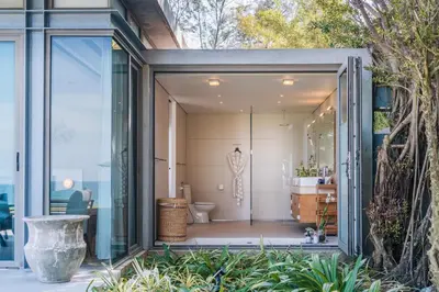 a glass extension of a bathroom with a toilet at Villa Essenza in Ban Han Pa To