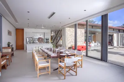 a dining room with a long table and chairs at Villa Malee Sai in Ban Han Pa To