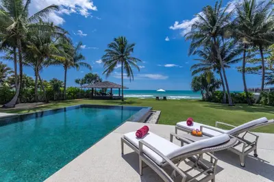 a villa with a swimming pool and the ocean at Villa Malee Sai in Ban Han Pa To