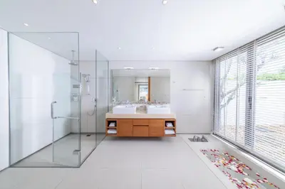 a bathroom with a sink and a shower and a mirror at Villa Malee Sai in Ban Han Pa To