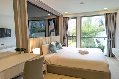 a bedroom with a large bed and a large window at 1 Bedroom 108-114 Pool View at Ozone Laguna near Bangtao Beach and Golf in Bang Tao Beach
