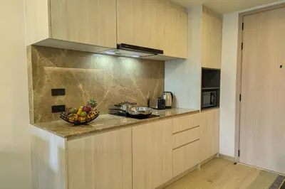 a kitchen with a bowl of fruit on a counter at 1 Bedroom 108-114 Pool View at Ozone Laguna near Bangtao Beach and Golf in Bang Tao Beach