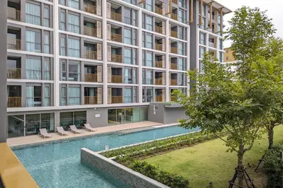an external view of a building with a swimming pool at 1 Bedroom 108-114 Pool View at Ozone Laguna near Bangtao Beach and Golf in Bang Tao Beach