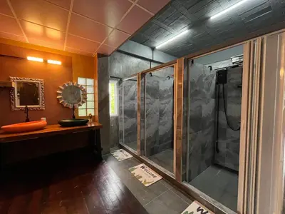 a bathroom with a shower and a sink at Nora Bukit Hotel in Ban Sam Kong
