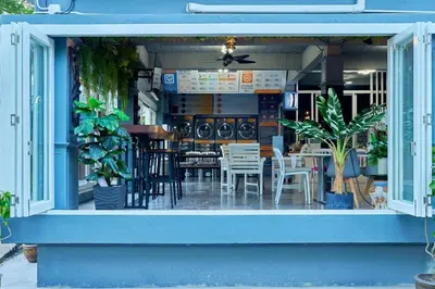 a restaurant with tables and chairs in the window at Nora Bukit Hotel in Ban Sam Kong