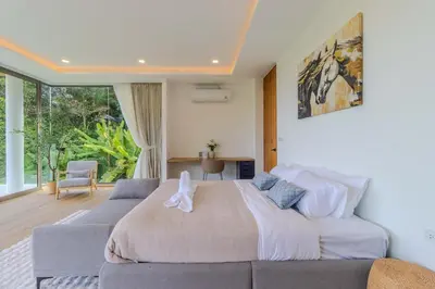 a bedroom with a large bed and a couch at V255 Huge Brand-New 7BR Pool Villa Rooftop View in Kata Beach