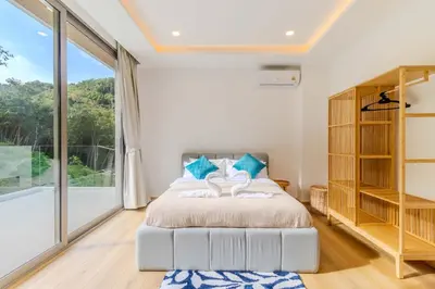 a bedroom with a bed and a large window at V255 Huge Brand-New 7BR Pool Villa Rooftop View in Kata Beach