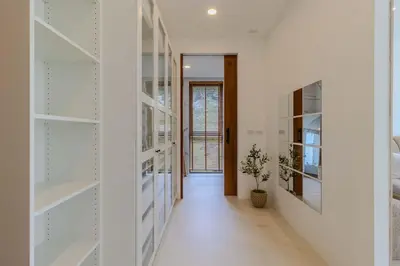 a hallway with white walls and glass shelves at V255 Huge Brand-New 7BR Pool Villa Rooftop View in Kata Beach