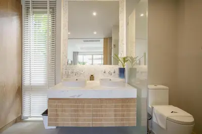 a bathroom with two sinks and a toilet at Stylish 3BR Pool Villa trichada Airport Shuttle in Phuket Town