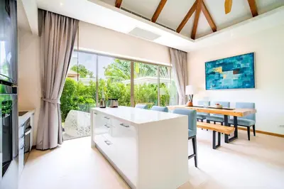 an open kitchen and dining room with a table and chairs at Private 3BR Villa trichad Airport and Maid in Phuket Town