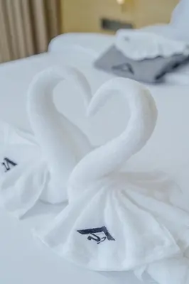 two swans wrapped in white towels on a table at Private 3BR Villa trichad Airport and Maid in Phuket Town