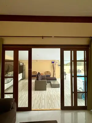 a living room with a sliding glass door at The glade in Ko Yao Noi