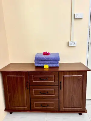 a wooden cabinet with a blue pillow on top of it at The glade in Ko Yao Noi