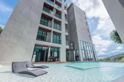 a building with a swimming pool in front of a building at Seaview 1 BR Apt at VV Patong C301 near Freedom Beach in Patong Beach