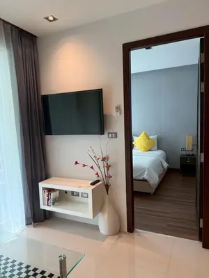 a living room with a television and a bed at Emerald Terrace Resort 622 in Patong Beach