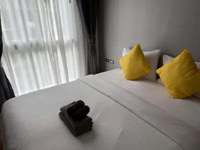 a hotel room with a bed with two teddy bears on it at Emerald Terrace Resort 622 in Patong Beach