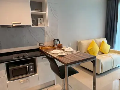 a small kitchen with a table and a couch at Emerald Terrace Resort 622 in Patong Beach