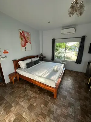 a bedroom with a bed and a large window at Maison Paradise Sea View in Patong Beach