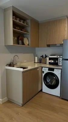 a kitchen with a washing machine and a dishwasher at Cozy apartments for a comfortable stay and accommodation in Phuket Town