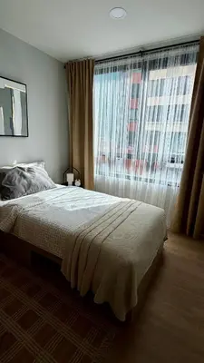 a bedroom with a bed and a large window at Cozy apartments for a comfortable stay and accommodation in Phuket Town